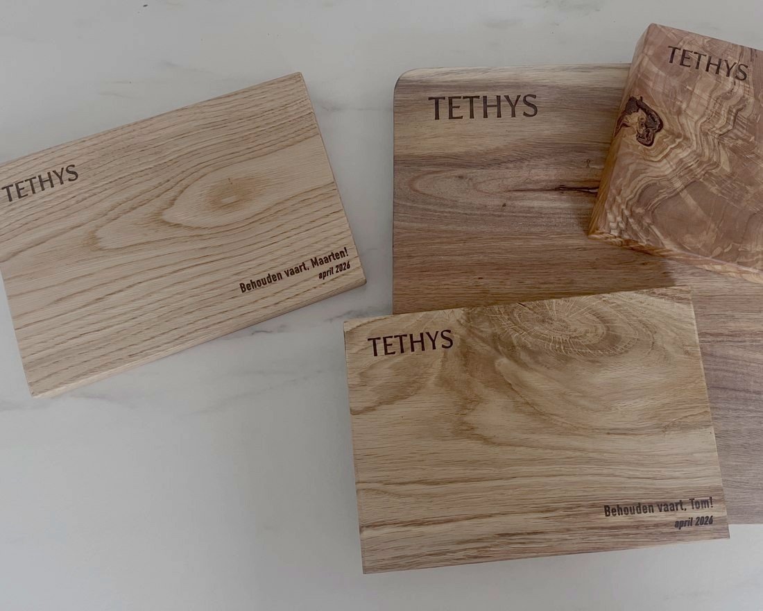 Lasercut houten planken met TETHYS-logo, gemaakt via Atelier Bovenop